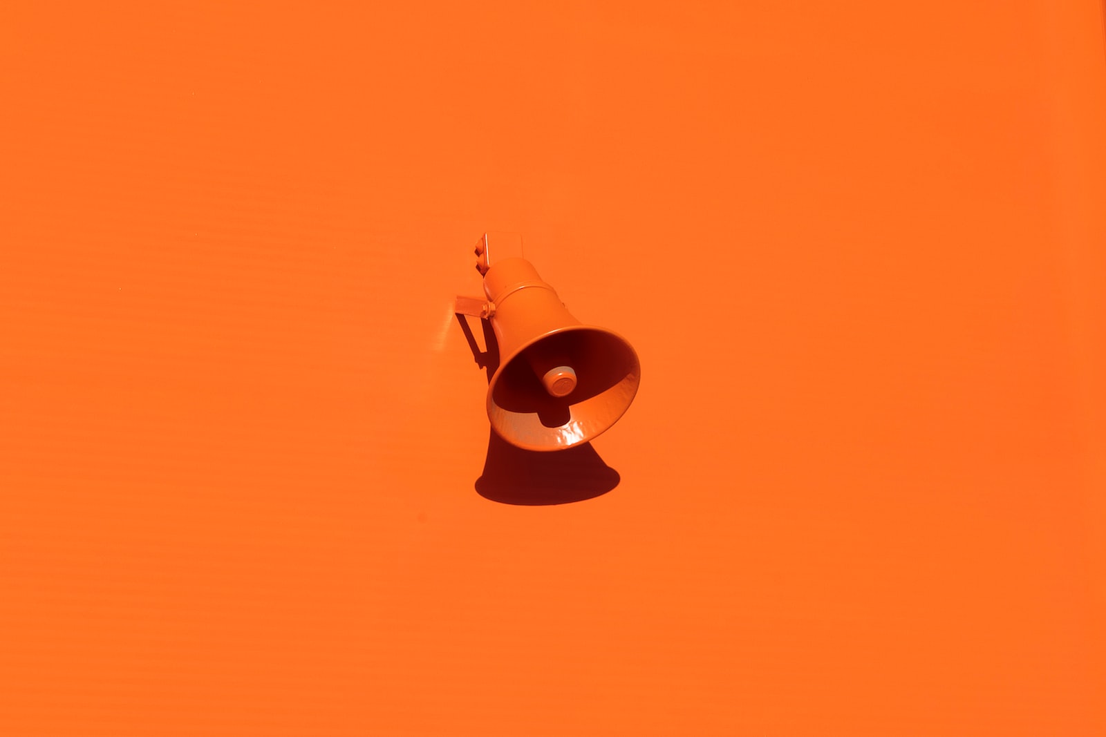 orange megaphone on orange wall